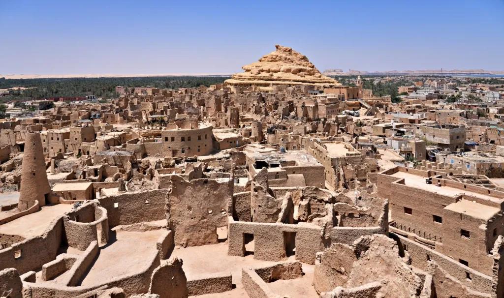 Ruins of Shali Fortress rising above Siwa town at sunset
