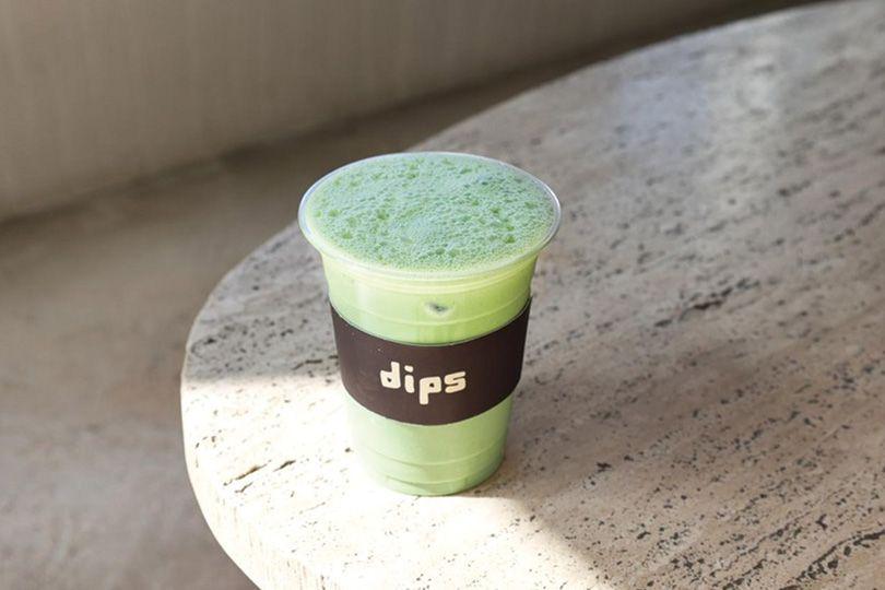 Iced matcha drinks lined up on a concrete counter at Dips Cafe, Jumeirah 2, Dubai