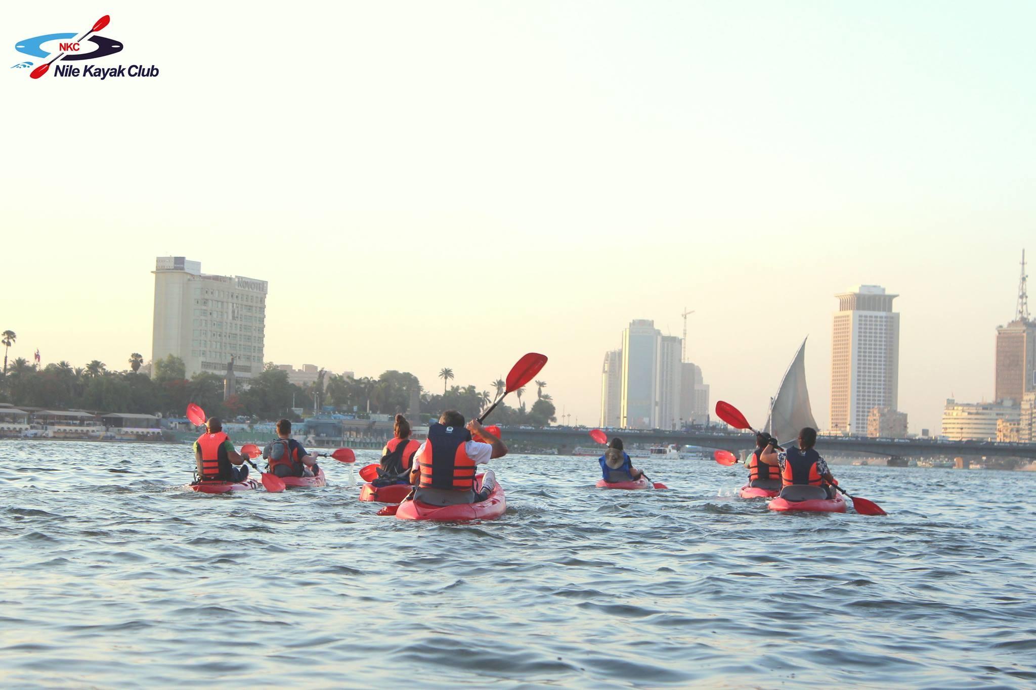 Calm Nile River view with palm trees lining the Cairo bank and buildings reflected on the water