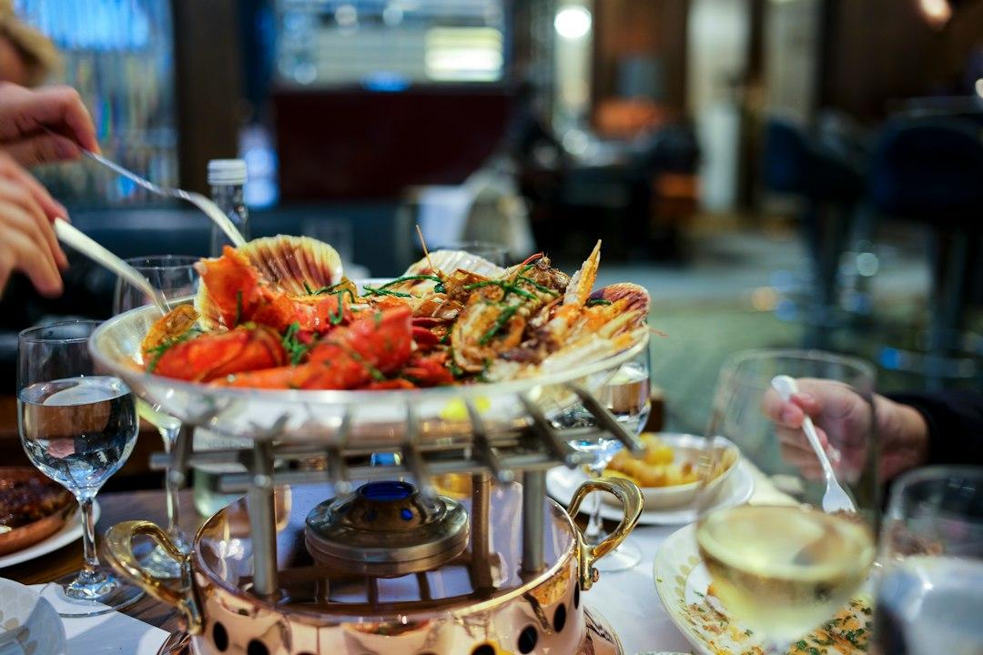 Grilled lobster and scallops on a silver platter over a copper chafing dish at an upscale London restaurant