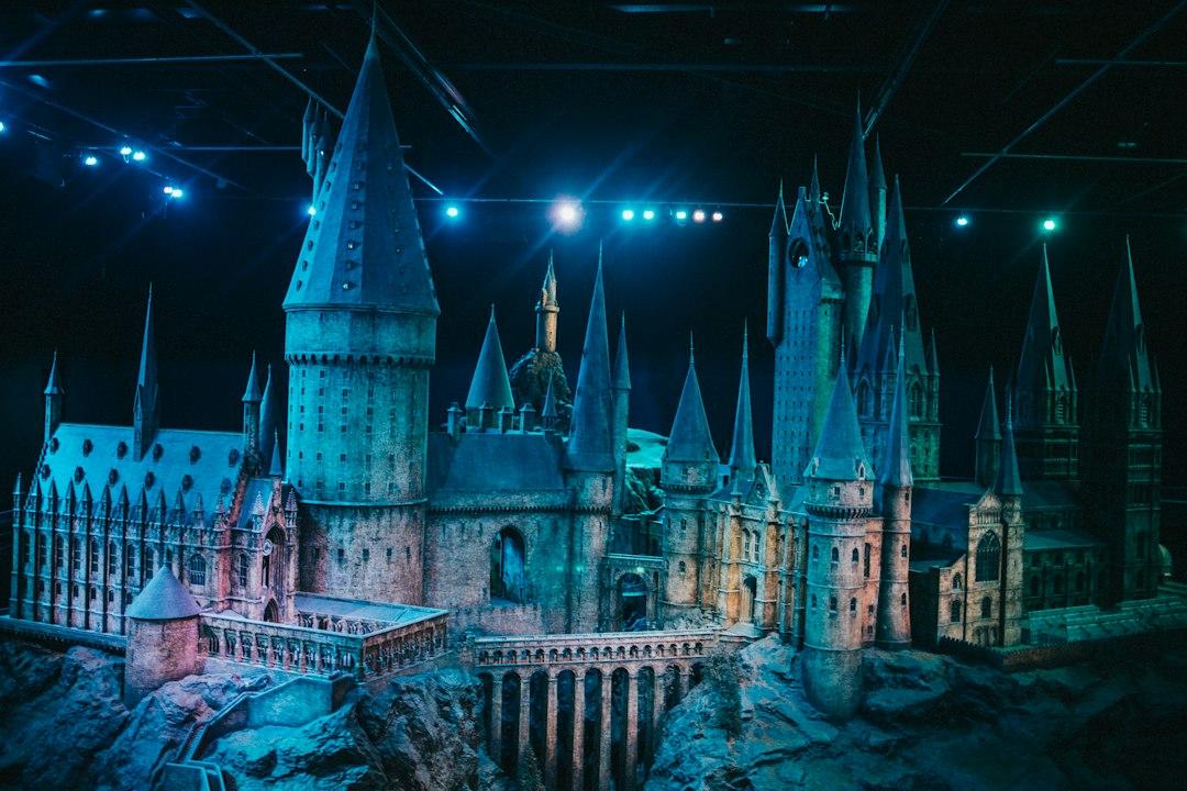 Detailed Hogwarts castle scale model dramatically lit with blue studio lights at Warner Bros. Studio Tour London