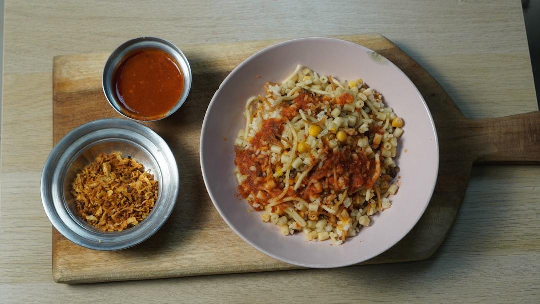 Afghan-style kabuli pulao rice with raisins and braised lamb on a decorative blue plate