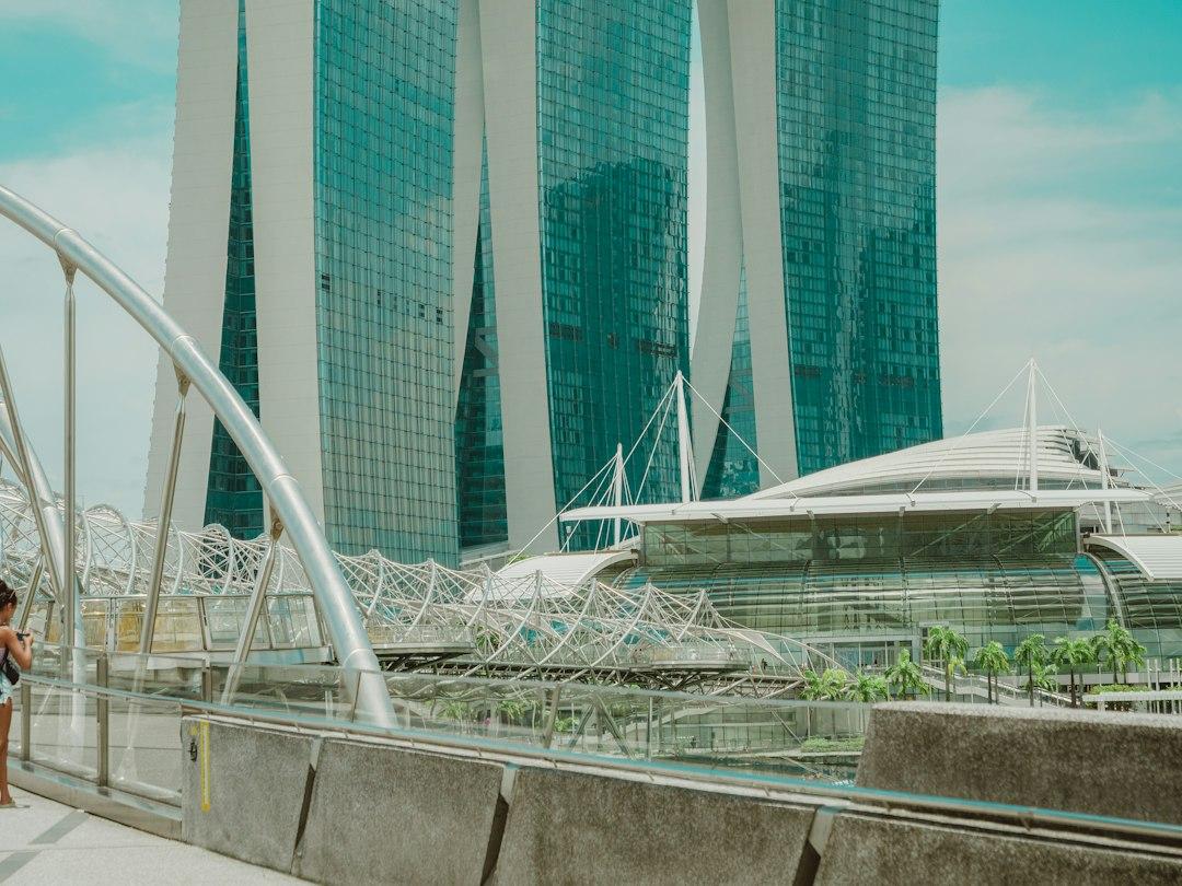Helix Bridge walkway with Marina Bay Sands towers and The Shoppes glass dome in Singapore