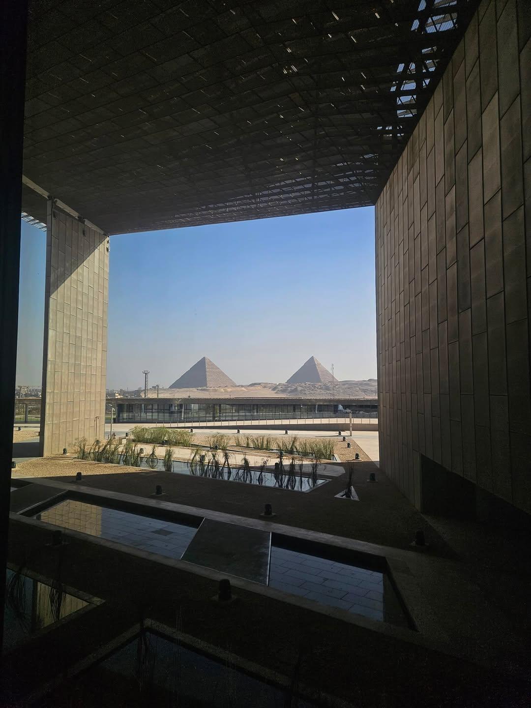Visitors viewing the open conservation lab through glass at the Grand Egyptian Museum