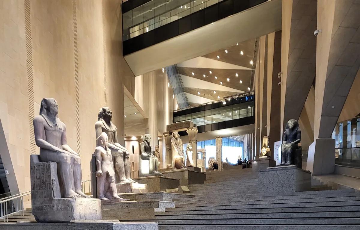 The Grand Staircase of the Grand Egyptian Museum lined with ancient royal statues