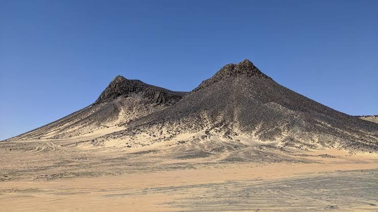 Black volcanic rock formations of the Black Desert near Bahariya Oasis at dusk