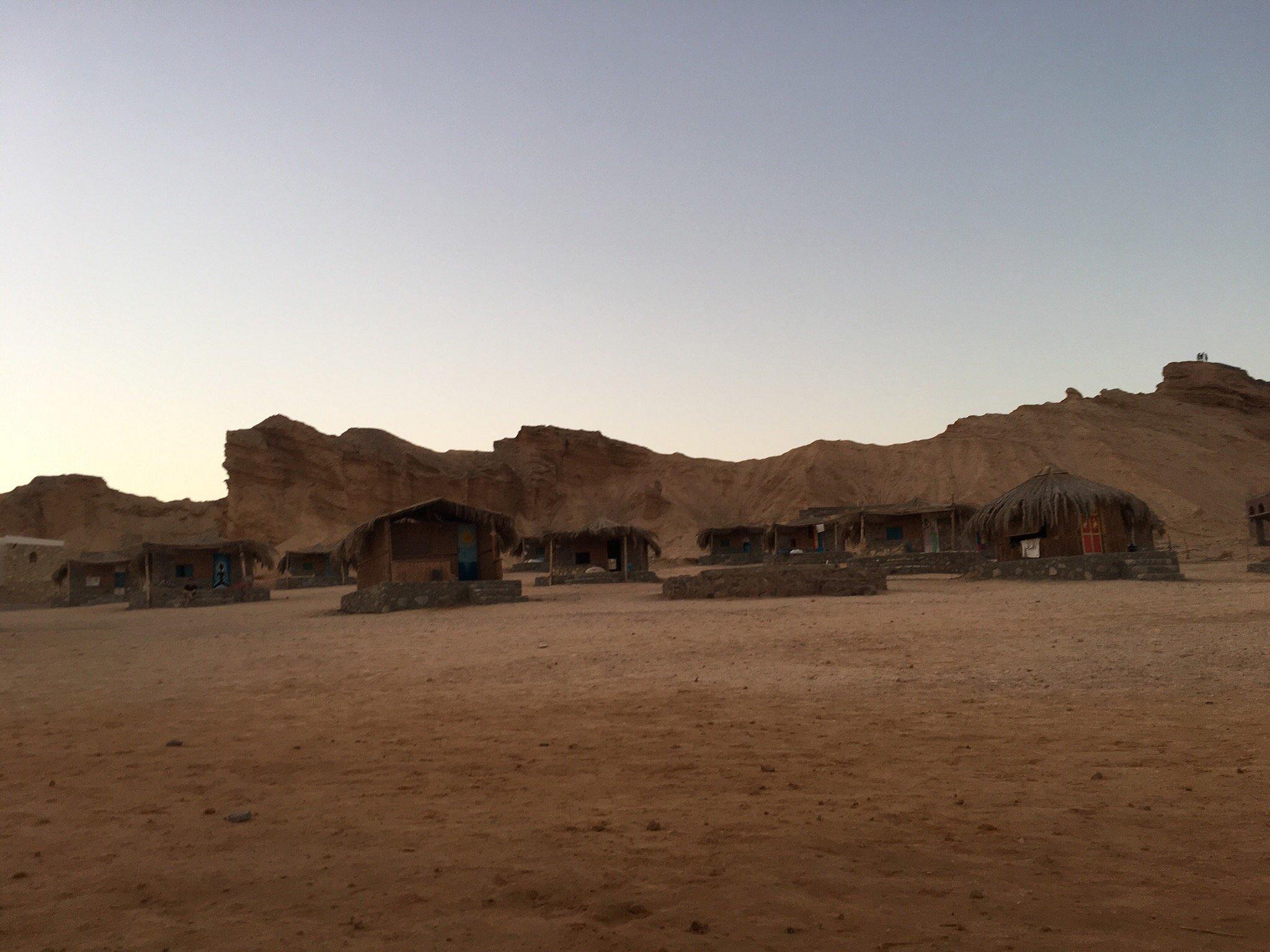 Bedouin beach huts with mountain backdrop at Ras Shetan on the Gulf of Aqaba near Nuweiba
