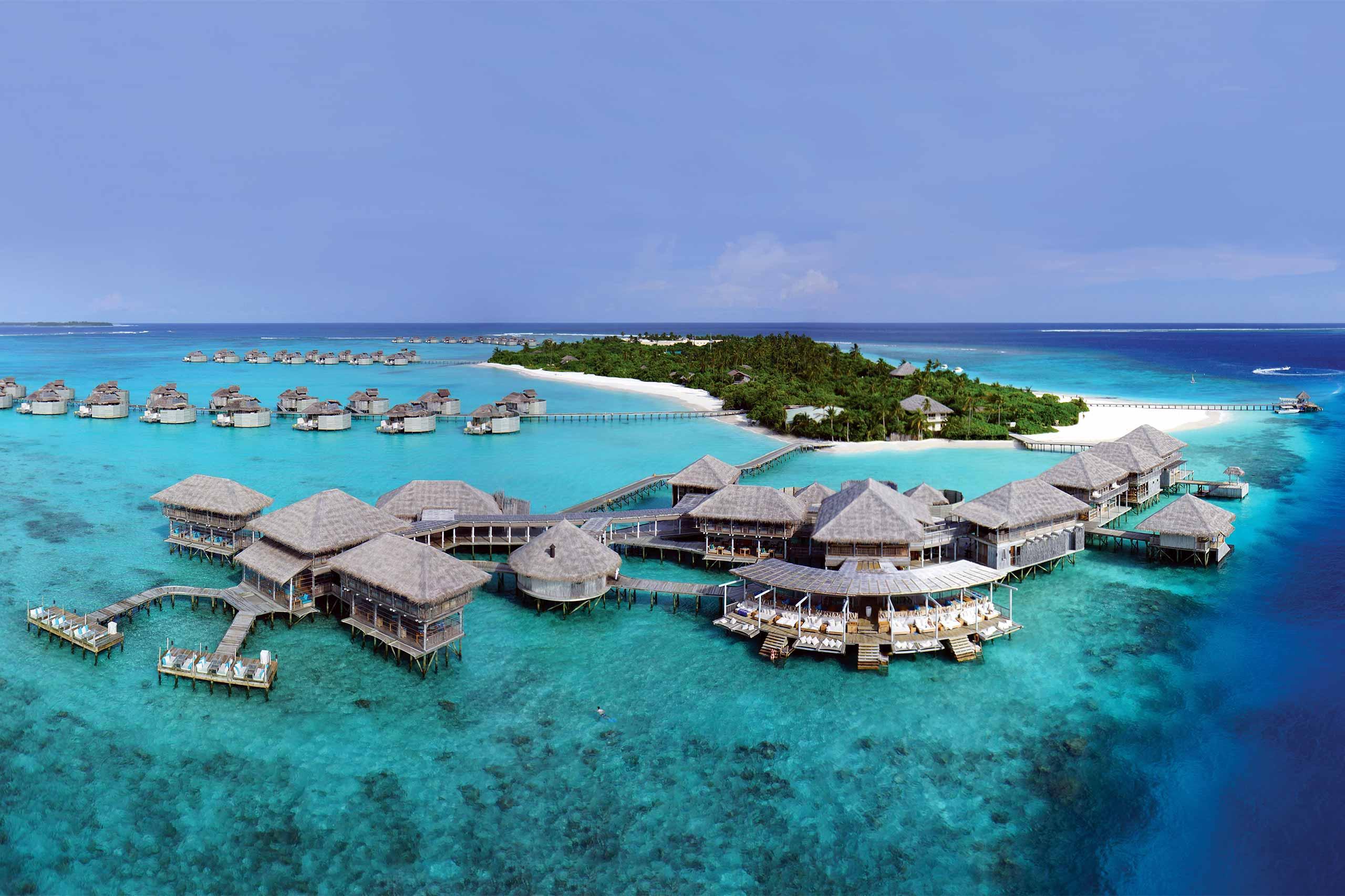 Overwater villa at Six Senses Laamu resort with thatched roof and lagoon views, Maldives