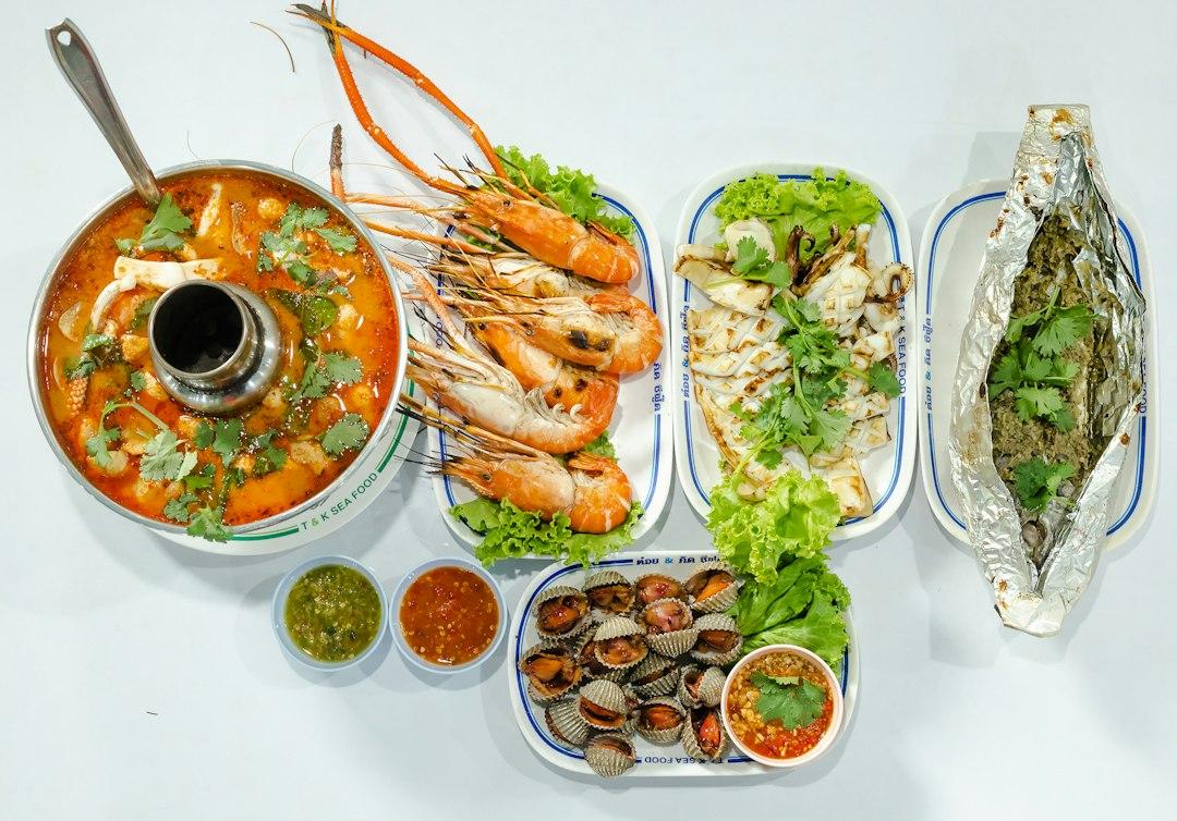 Thai seafood spread at T&K Sea Food: tom yum soup, grilled prawns, squid, cockles, foil-wrapped fish, and dipping sauces