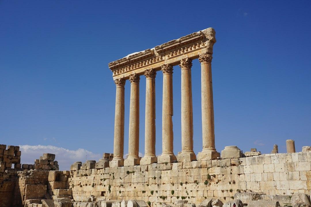 Six towering Corinthian columns of the Temple of Jupiter standing against a clear blue sky at Baalbek, Lebanon