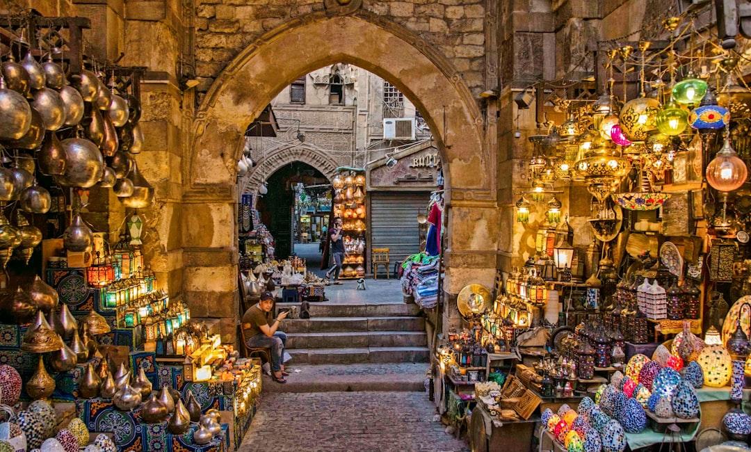 El Fishawy café entrance in Khan el-Khalili with glowing Arabic signs and ornate hanging lanterns at night