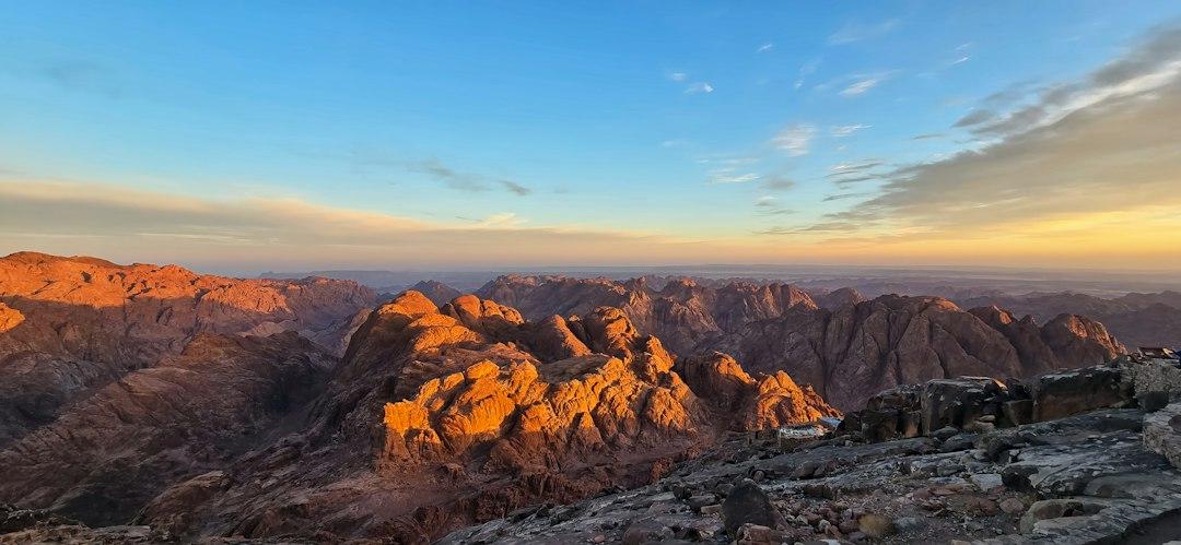 Golden sunrise light bathing the rugged granite peaks of Mount Sinai, viewed from the summit at 2,285m, Sinai Peninsula, Egypt