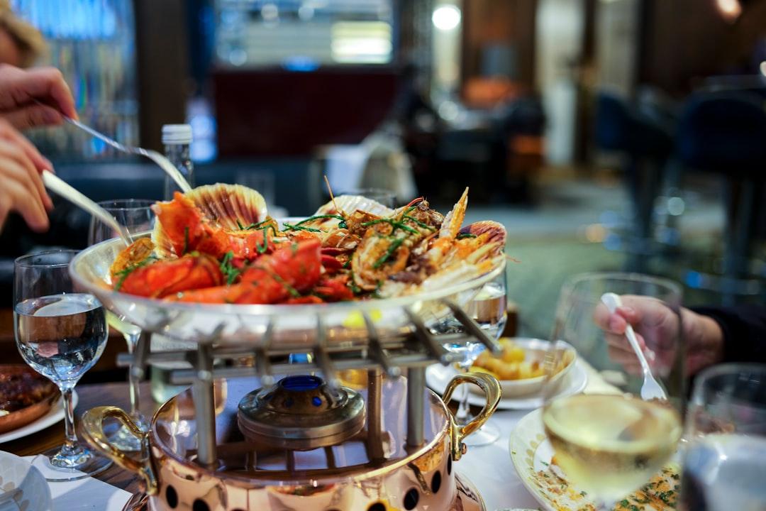 Lavish seafood platter with lobster and scallops on a copper chafing dish, served at an elegant Alexandria restaurant