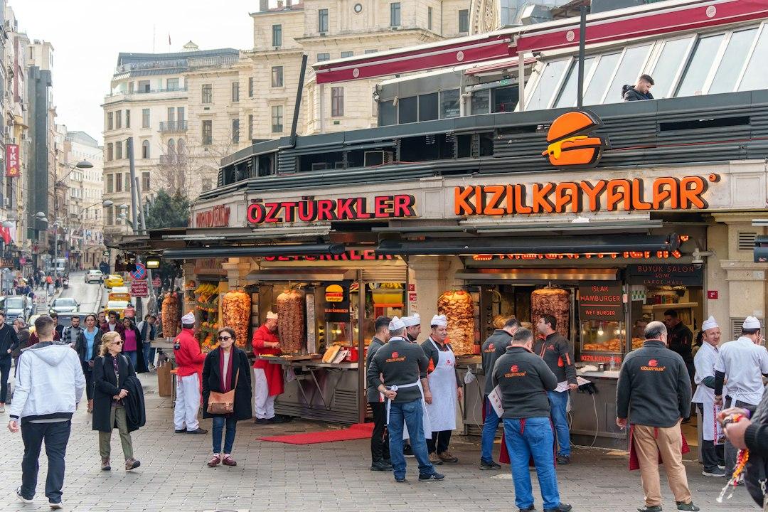 Kizilkayalar wet burger street food stall on a busy Istanbul pedestrian square with vendors and crowds
